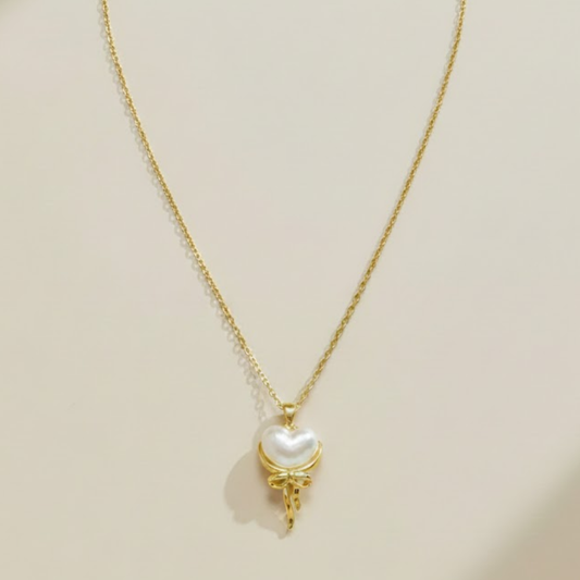 Delicate gold necklace with pearl heart