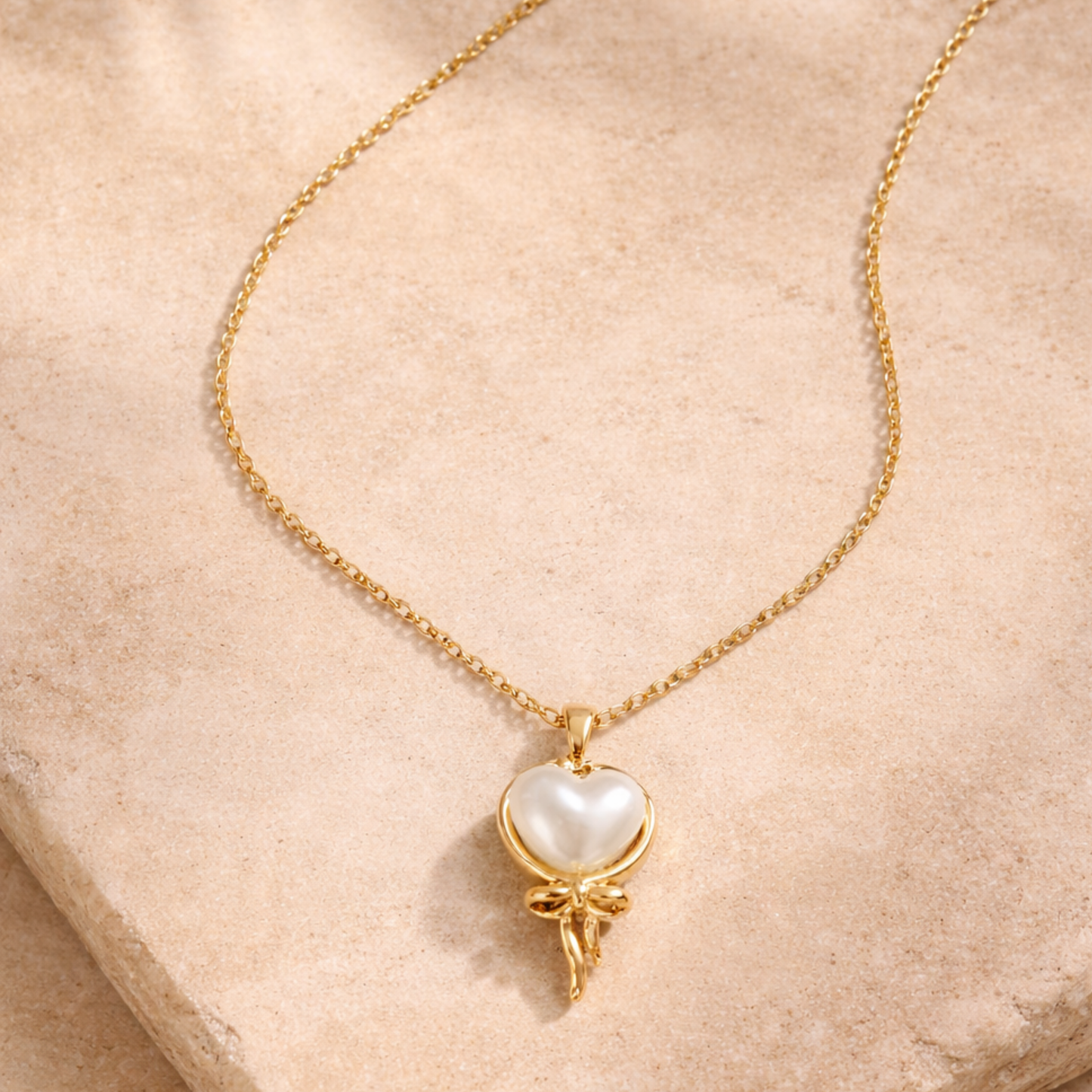 Delicate gold necklace with pearl heart
