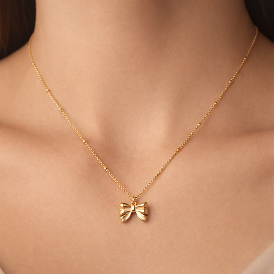 Gold satellite Bow tie necklace