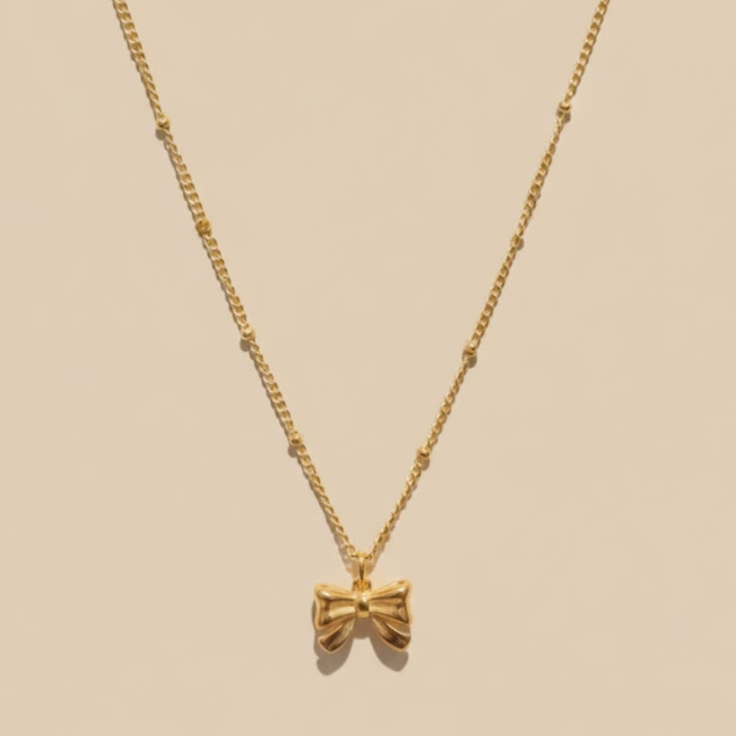 Gold satellite Bow tie necklace
